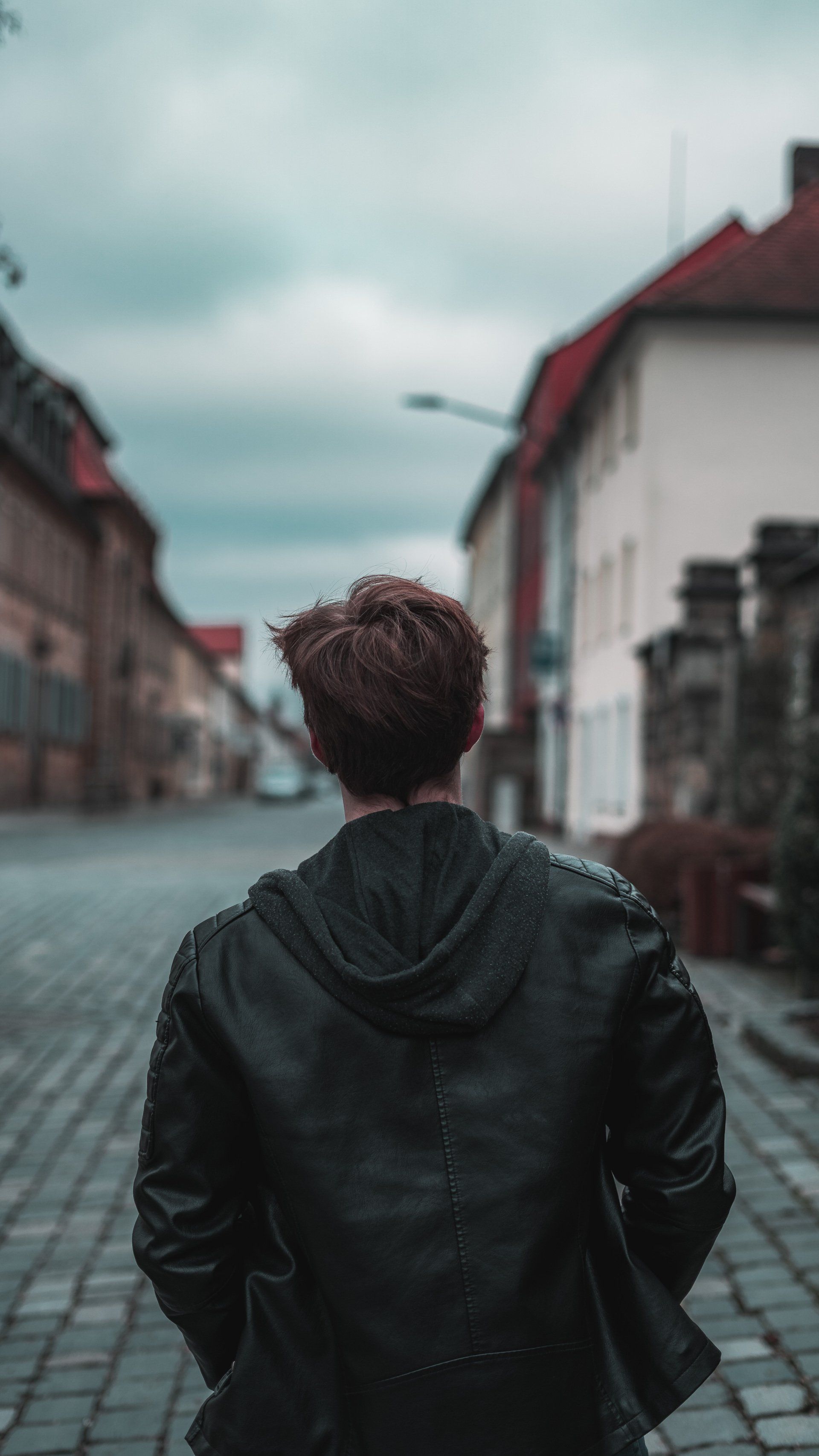 Portrait von jungen Mann in Lederjacke mit Rücken zur Kamera, Bild von Fotograf Hannes Schmidt