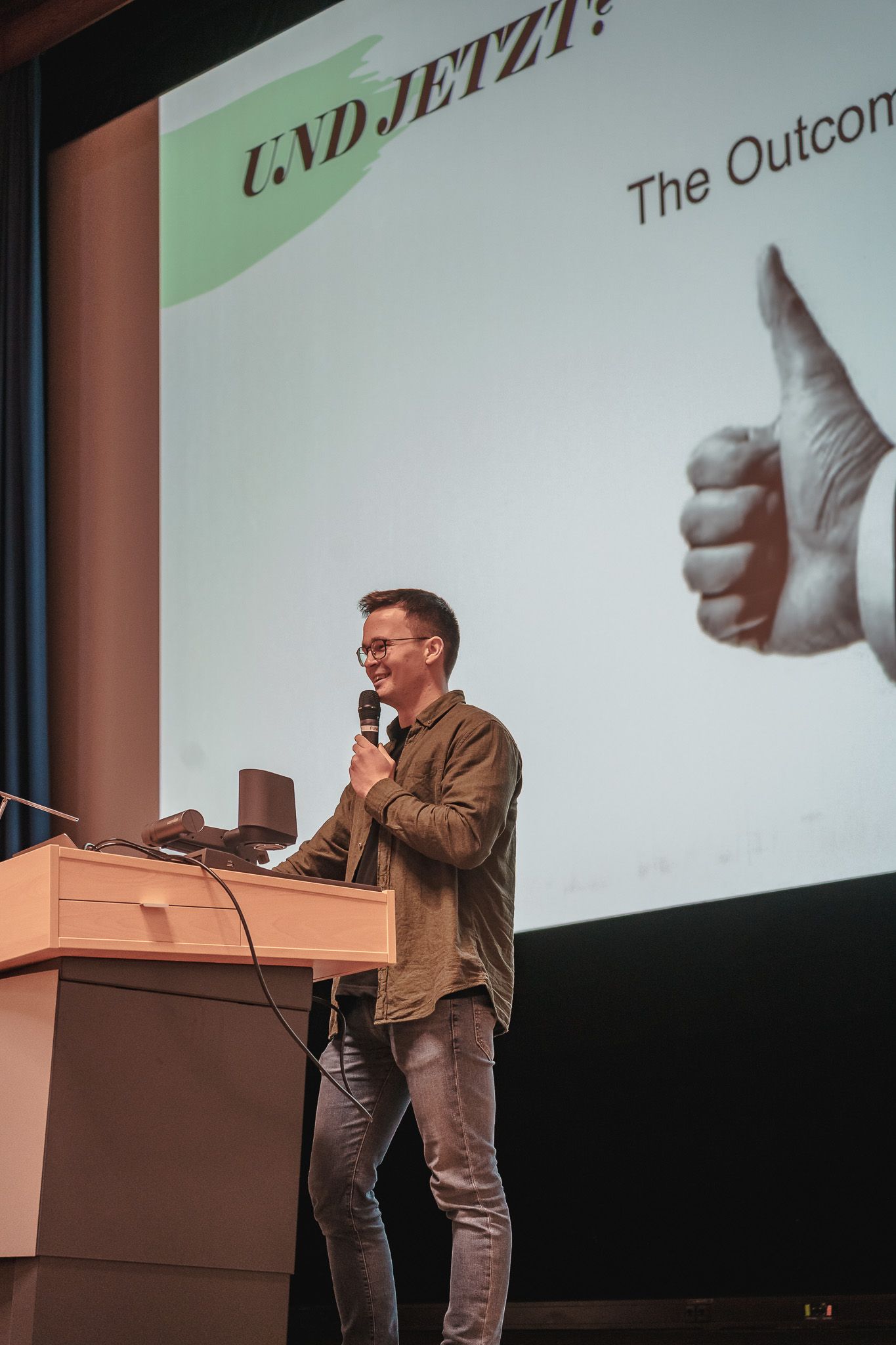 Teilnehmer auf der Bühne am Vortragen bei der PowerPoint Karaoke von Fotograf Hannes Schmidt in Aachen