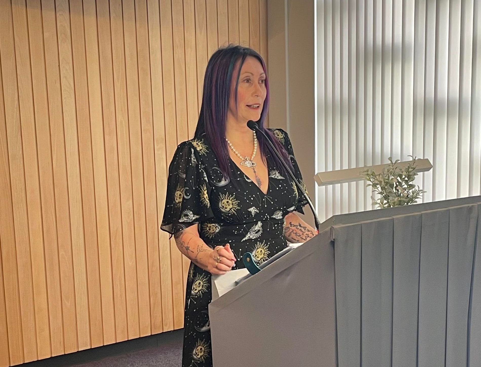 civil celebrant behind a lecturn conducting a funeral
