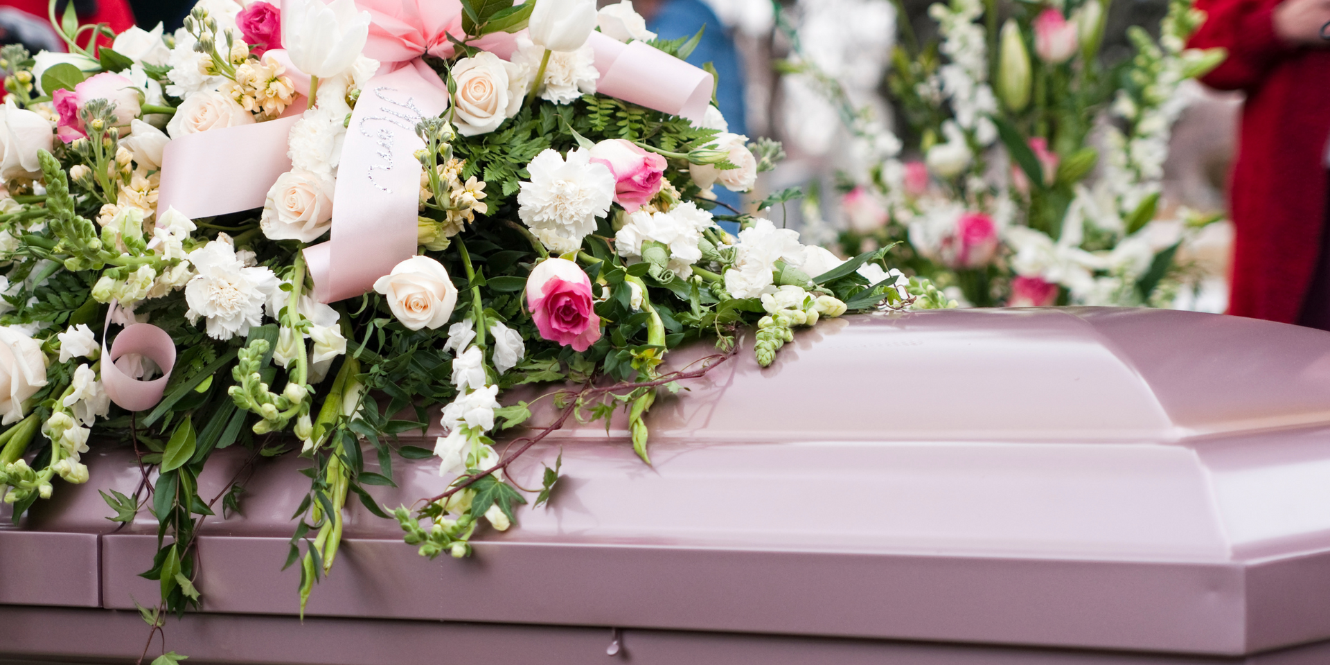 pink funeral casket & flowers