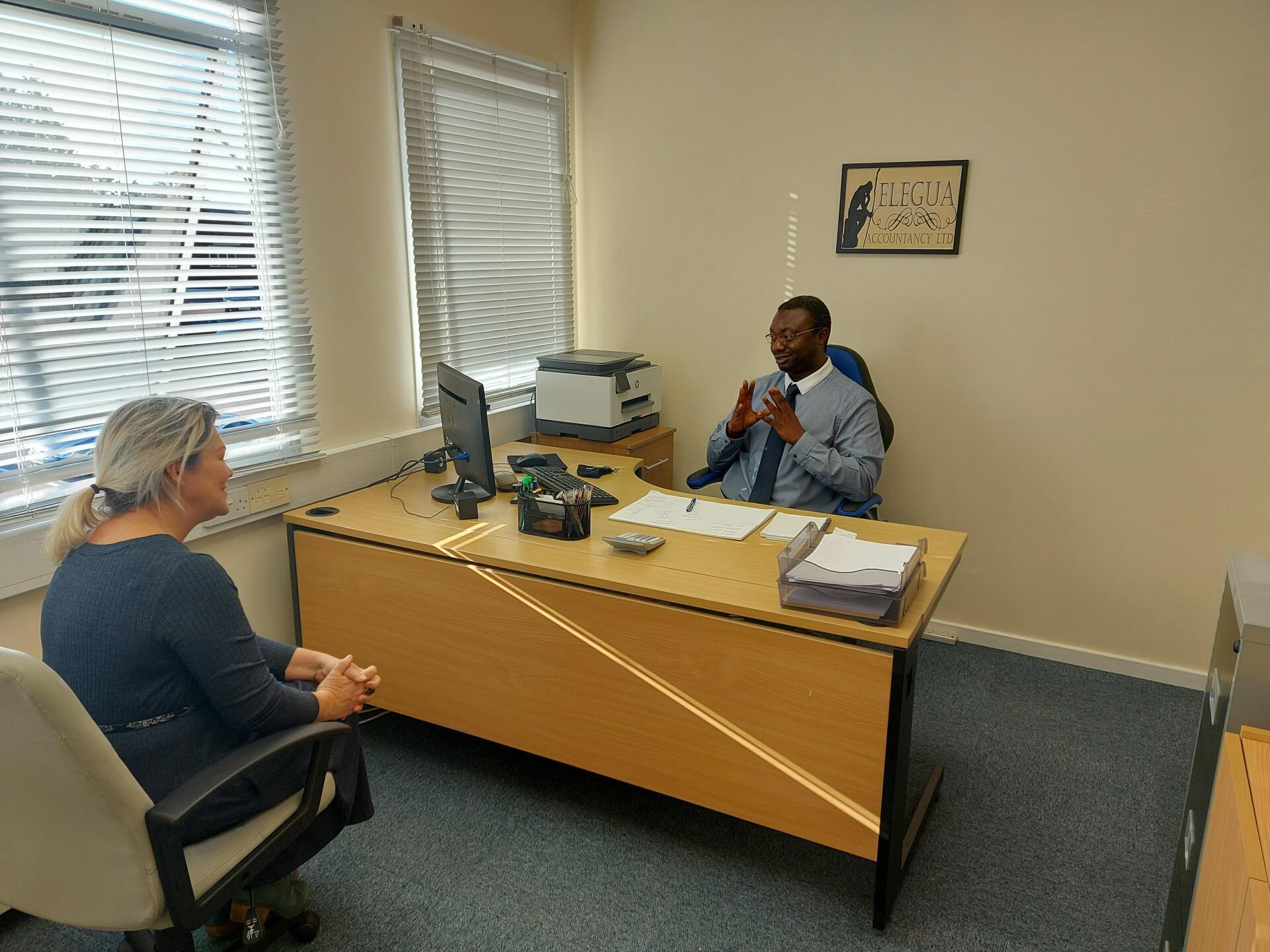 Adedayo Akande with a client.