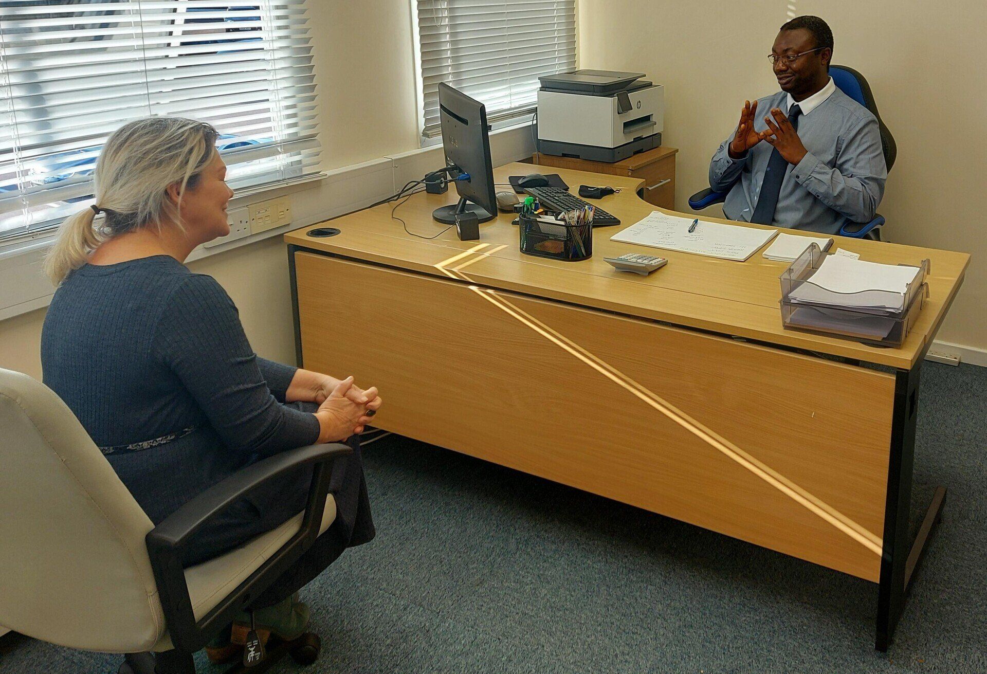 Accountant, Adedayo Akande, giving tax advice at Redhill office