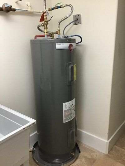 Bruce's Plumbing  - New water heater installation with stainless connectors and a pressed aluminum pan.
