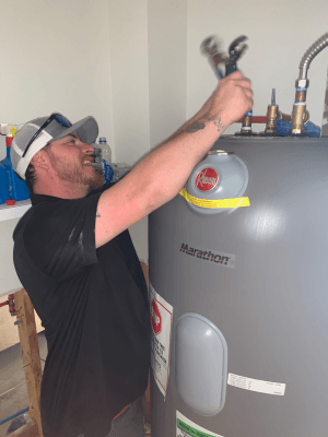 Bruce's Plumbing in Gulf Shores, AL has an employee replacing a water heater.