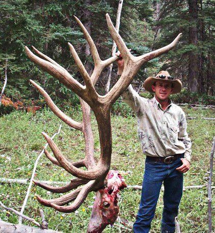 Man holding up antlers