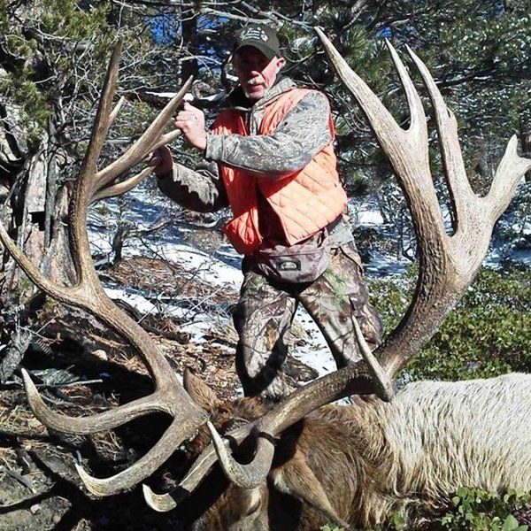 Elk Hunting Trip in Arizona Man holding up large elk antlers