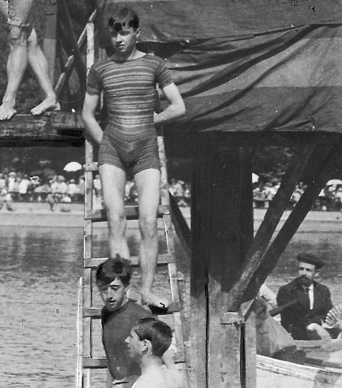 Jóvenes participando en el juego de cucaña en el estanque del Retiro (1908)