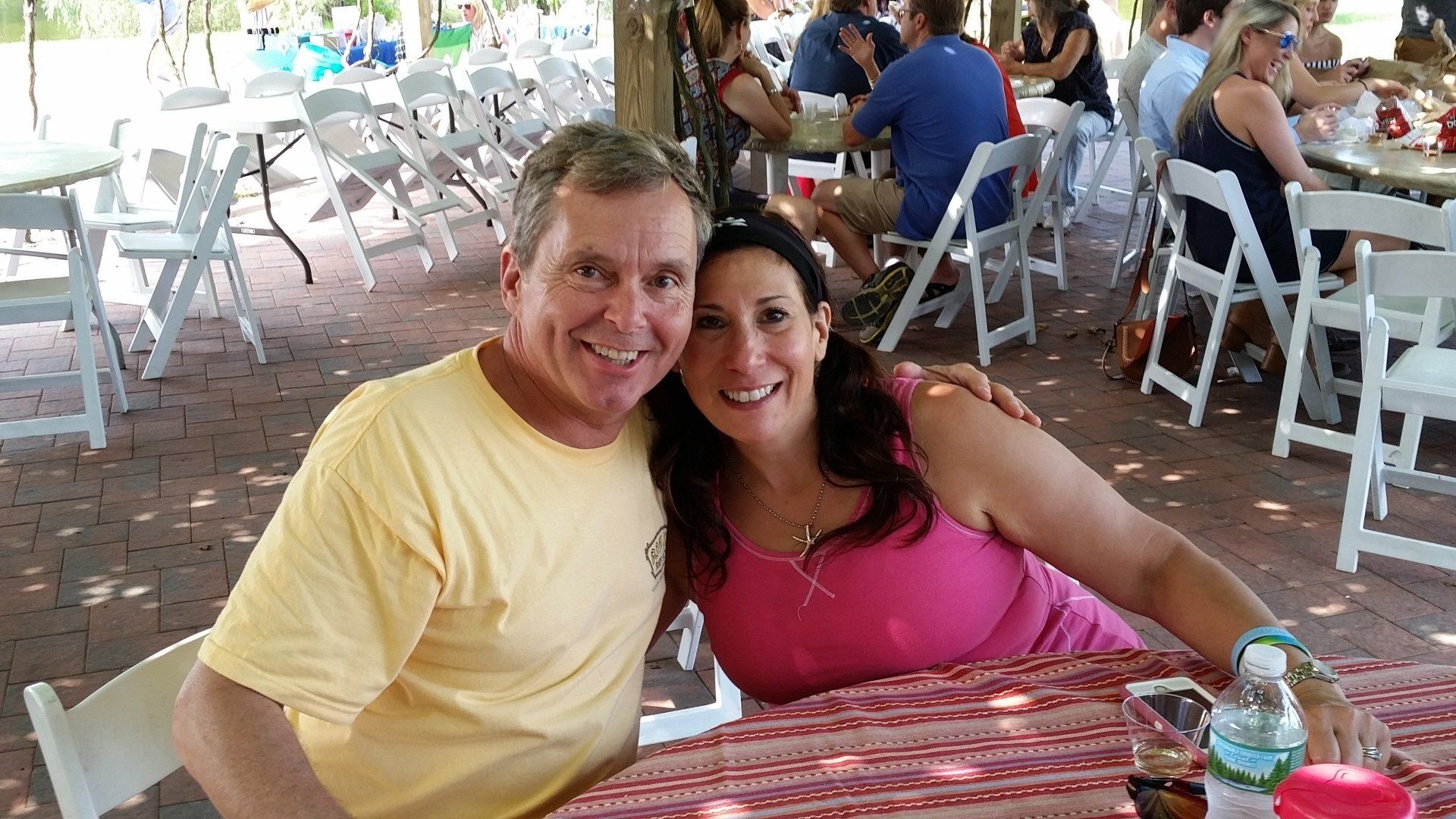 A couple sitting at a winery.