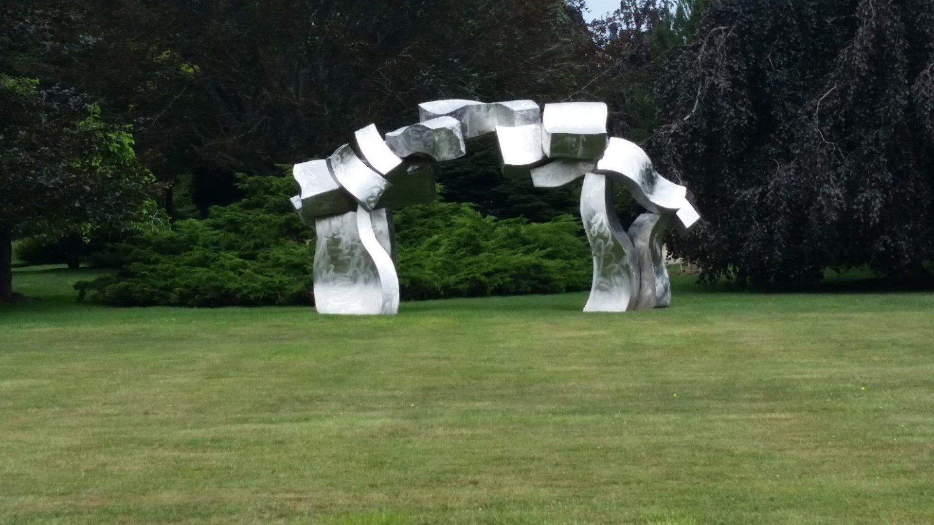 Large outdoor sculpture in a field.