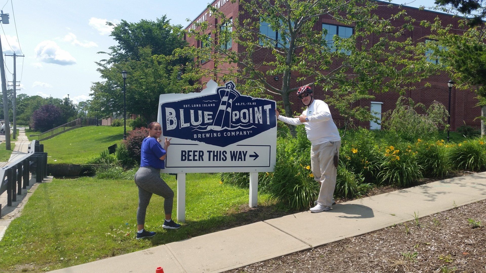 A couple in front of a sign reading A couple in front of a sign reading