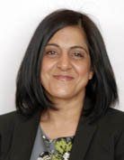 Head and shoulders image of a woman with dark hair wearing dark clothing