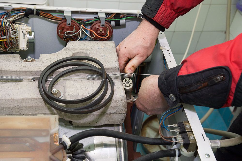 K&L Repairman Fixing Dryer Image