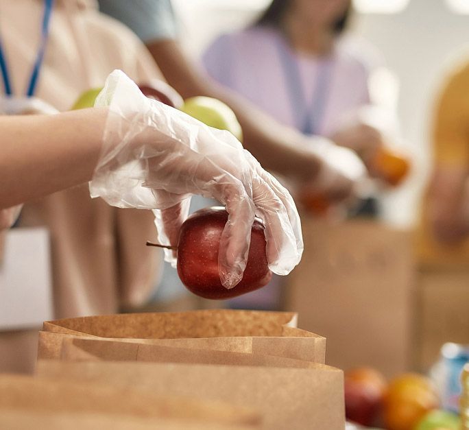 Volunteer packing bags of food for distributions.