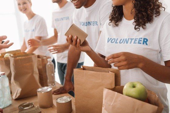 a group of volunteers packing lunches