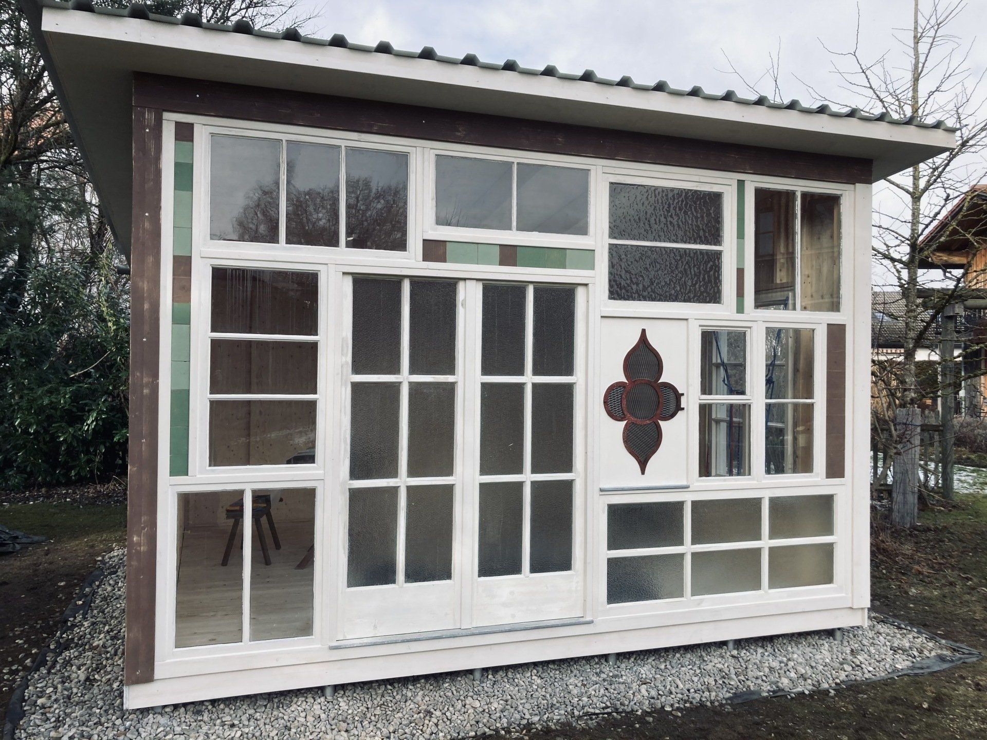 Gartenhaus mit antiken Fenstern in München, handgefertigt aus Holz und Glas