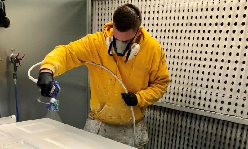 photo of a painter spray painting