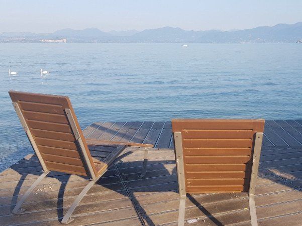 two deck chairs looking out over Lake Garda, Italy