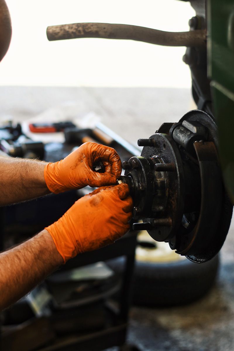 Close-up of technicians hands working an a wheel