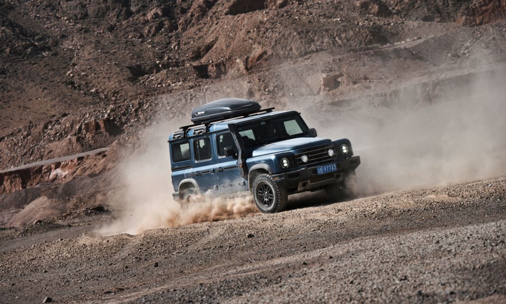 INEOS Grenadier driving off-road in desert terrain