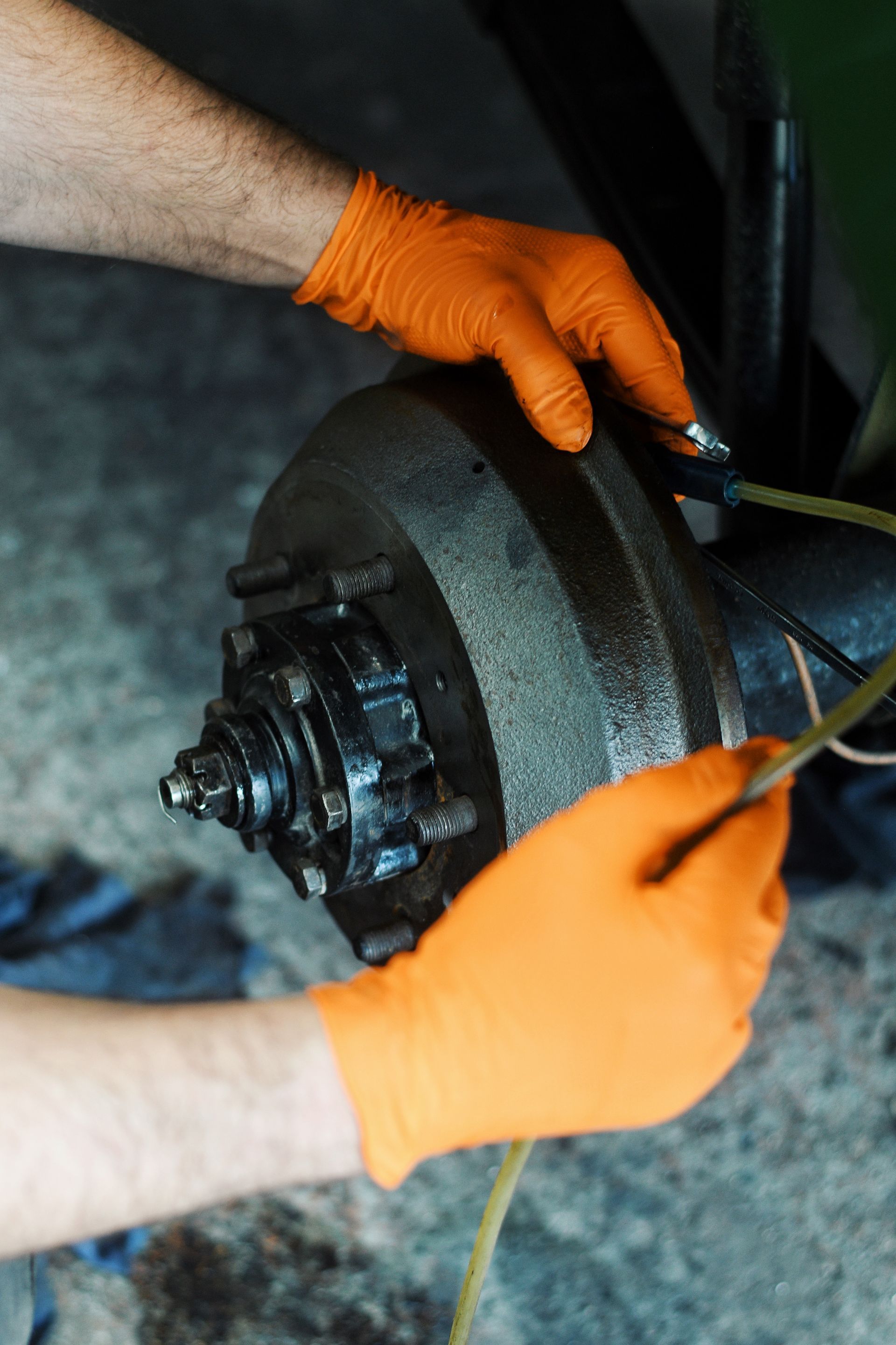 Close-up of technician examining wheel for Land Rover Series 2
