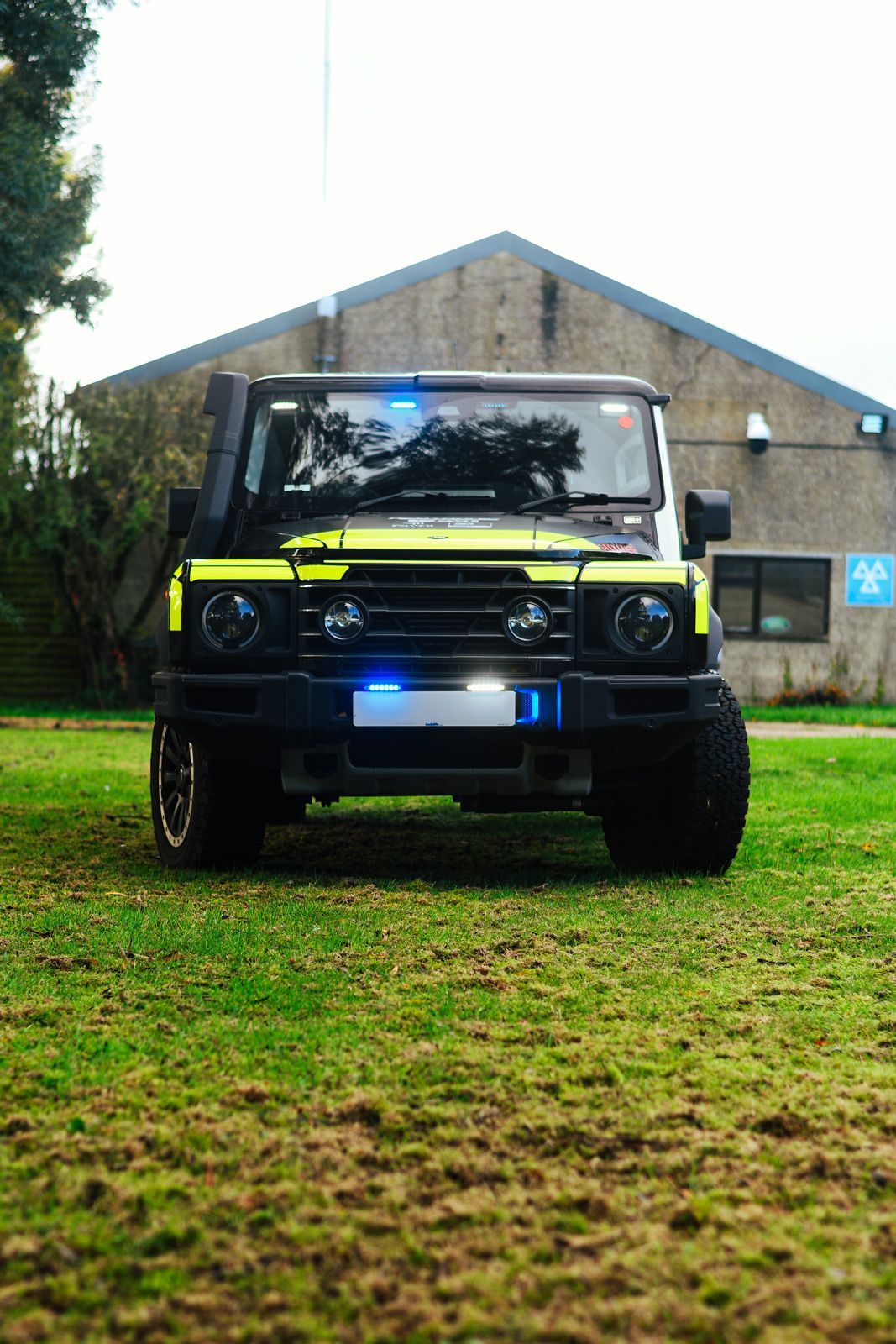 Front view of an Emergency INEOS Grenadier Trialmaster on grass.