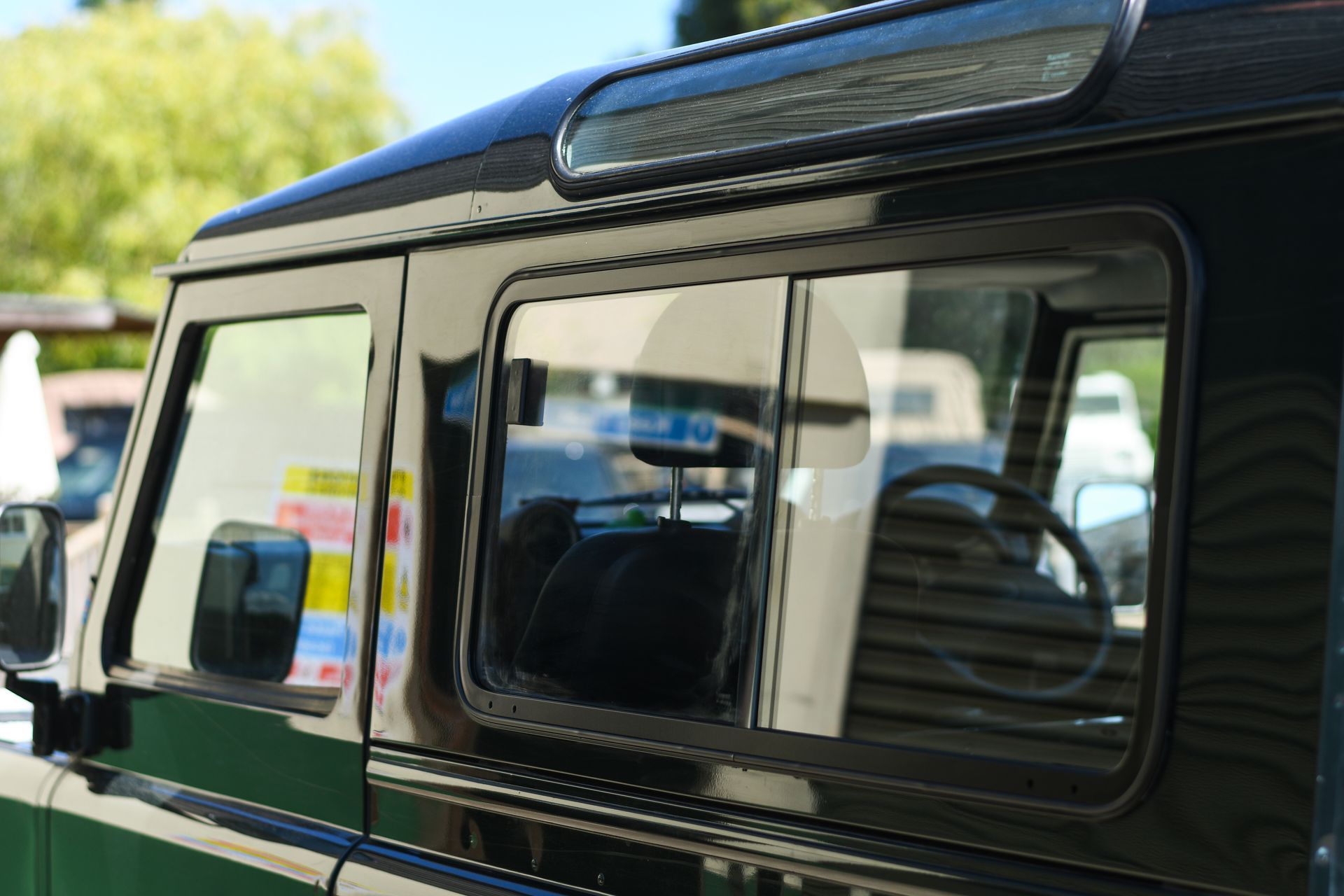 Rear view window of Green Land Rover Defender 90