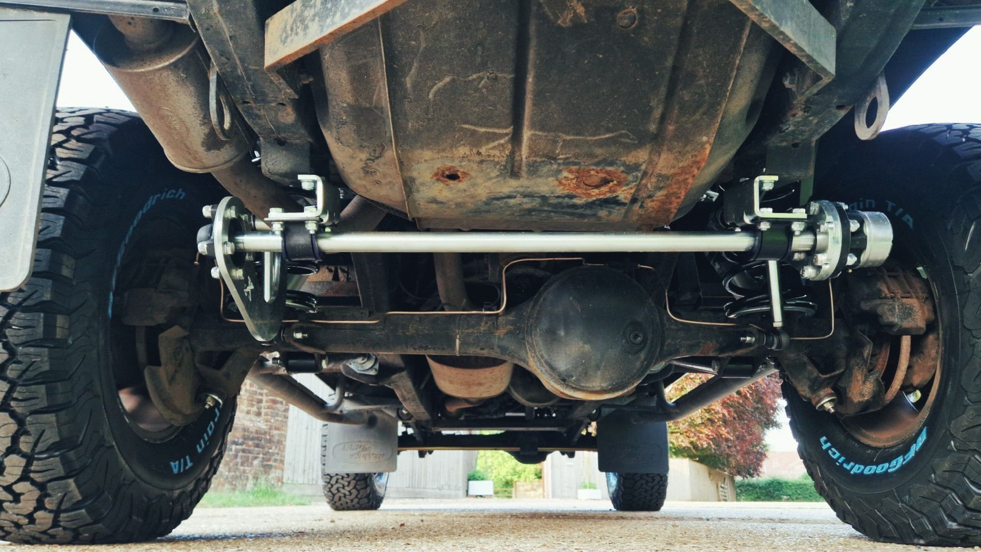 Underside of Land Rover Defender showing upgraded suspension and axle components