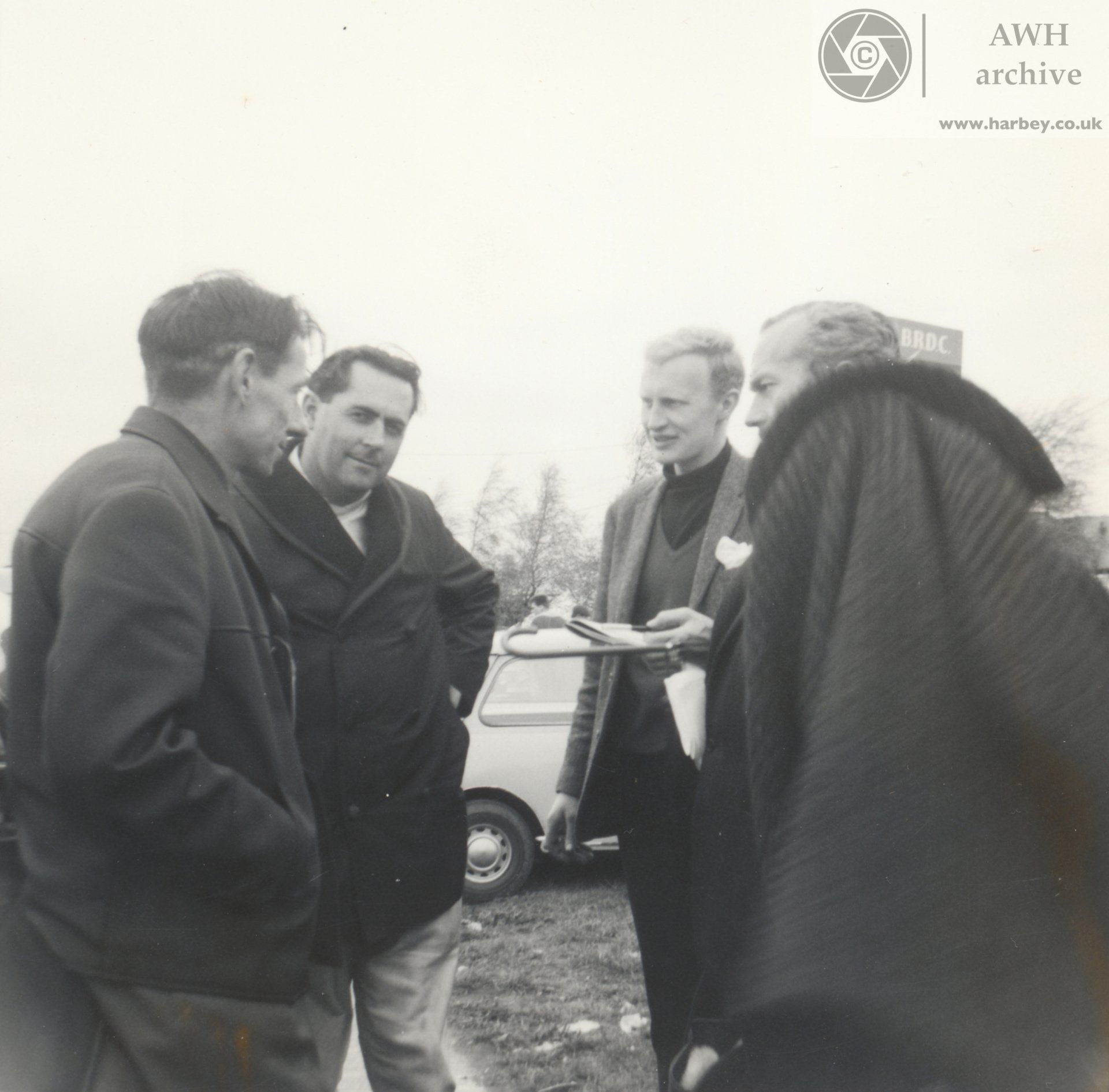 Brabham, Chapman, Ginther in the paddock.