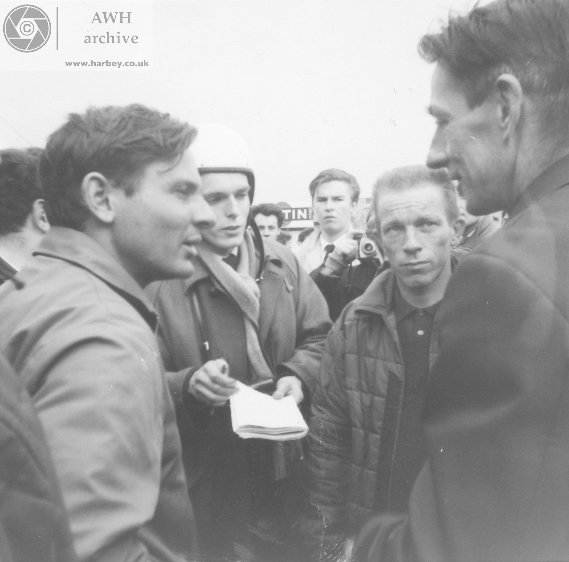 Brabham, Chapman, Ginther in the paddock.