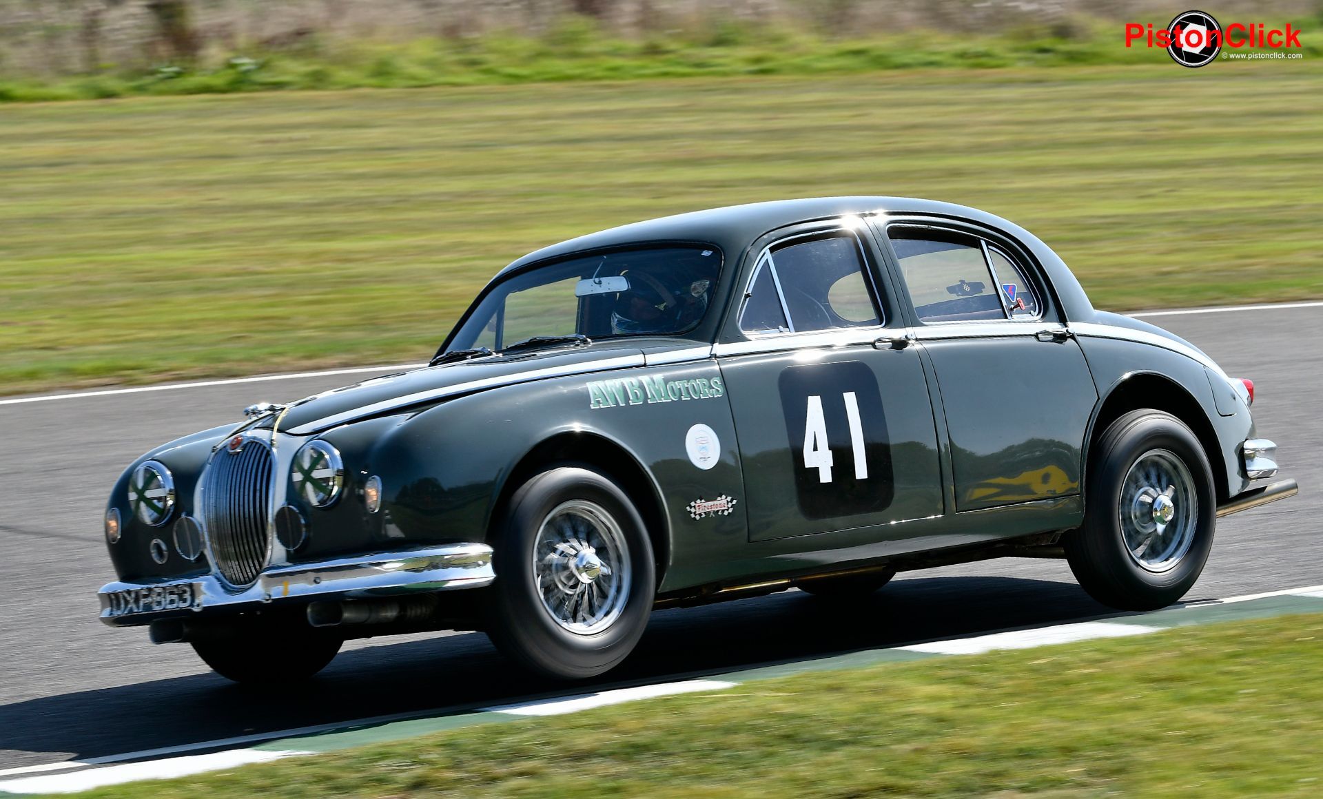 Rob Huff bouncing the Jag Mk1 off the kerbs
