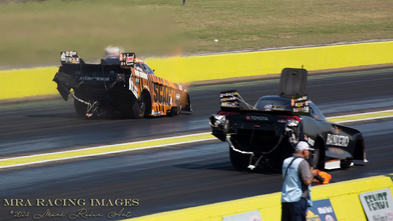 Alexis Dejoria’s car sits abandoned in the right lane as Daniel Wilkerson speeds past in E1