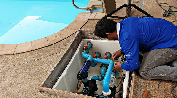 man fixing pool pipe
