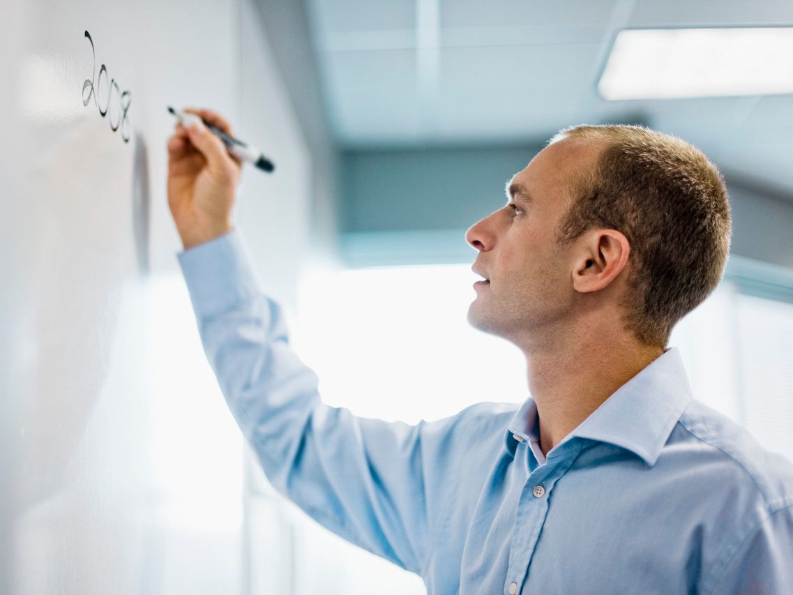 A dedicated Solicitor working out calculations on a whiteboard