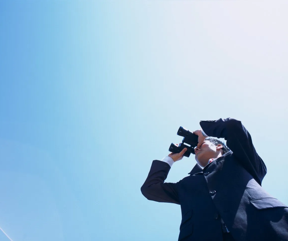 We see the big picture Person looking at the horizon with a spyglass