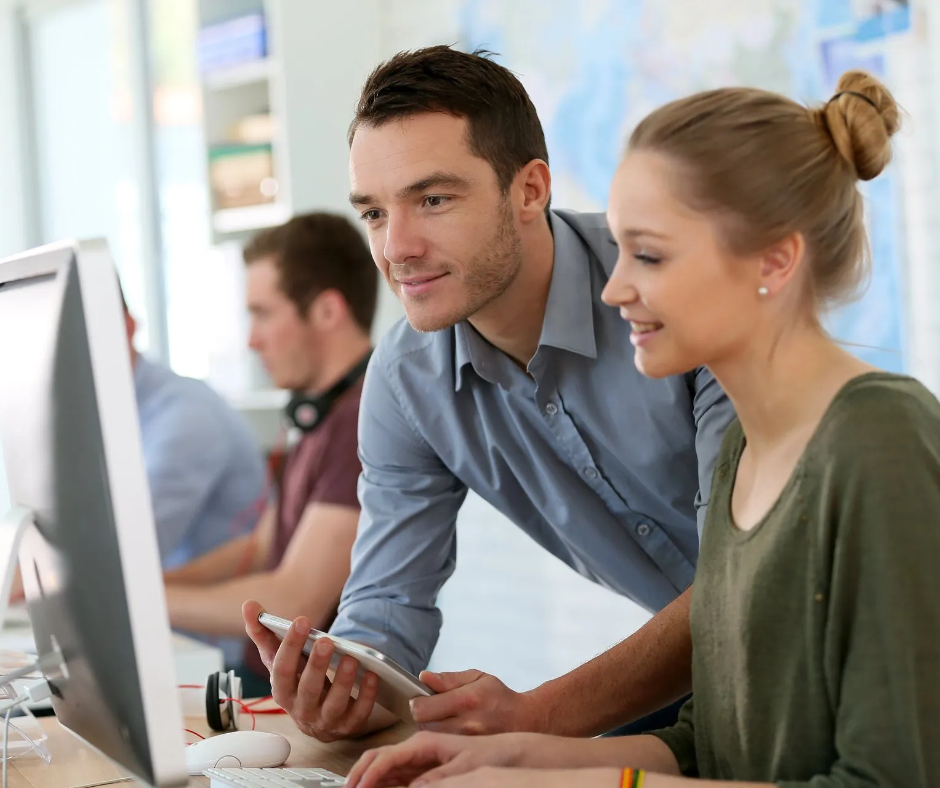 Professional Tableau Trainings by licensed Trainers Man is supporting woman with computer work