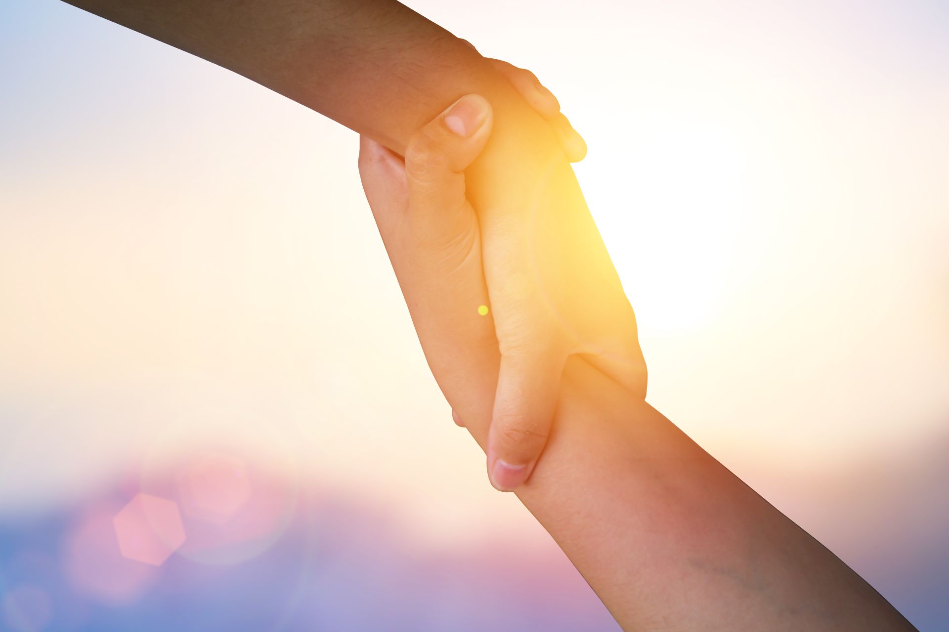 two hands holding each other