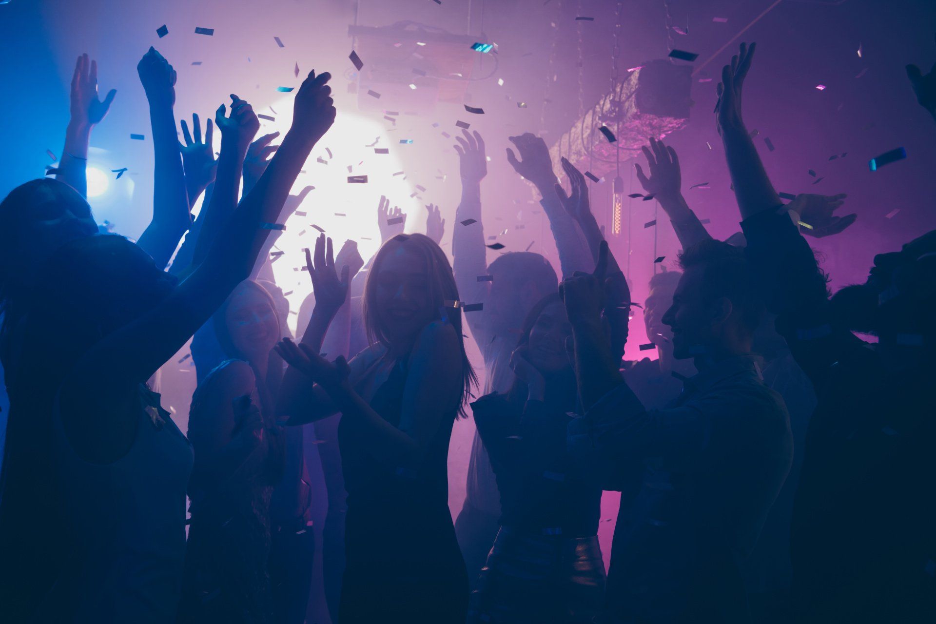 People dance in a nightclub.