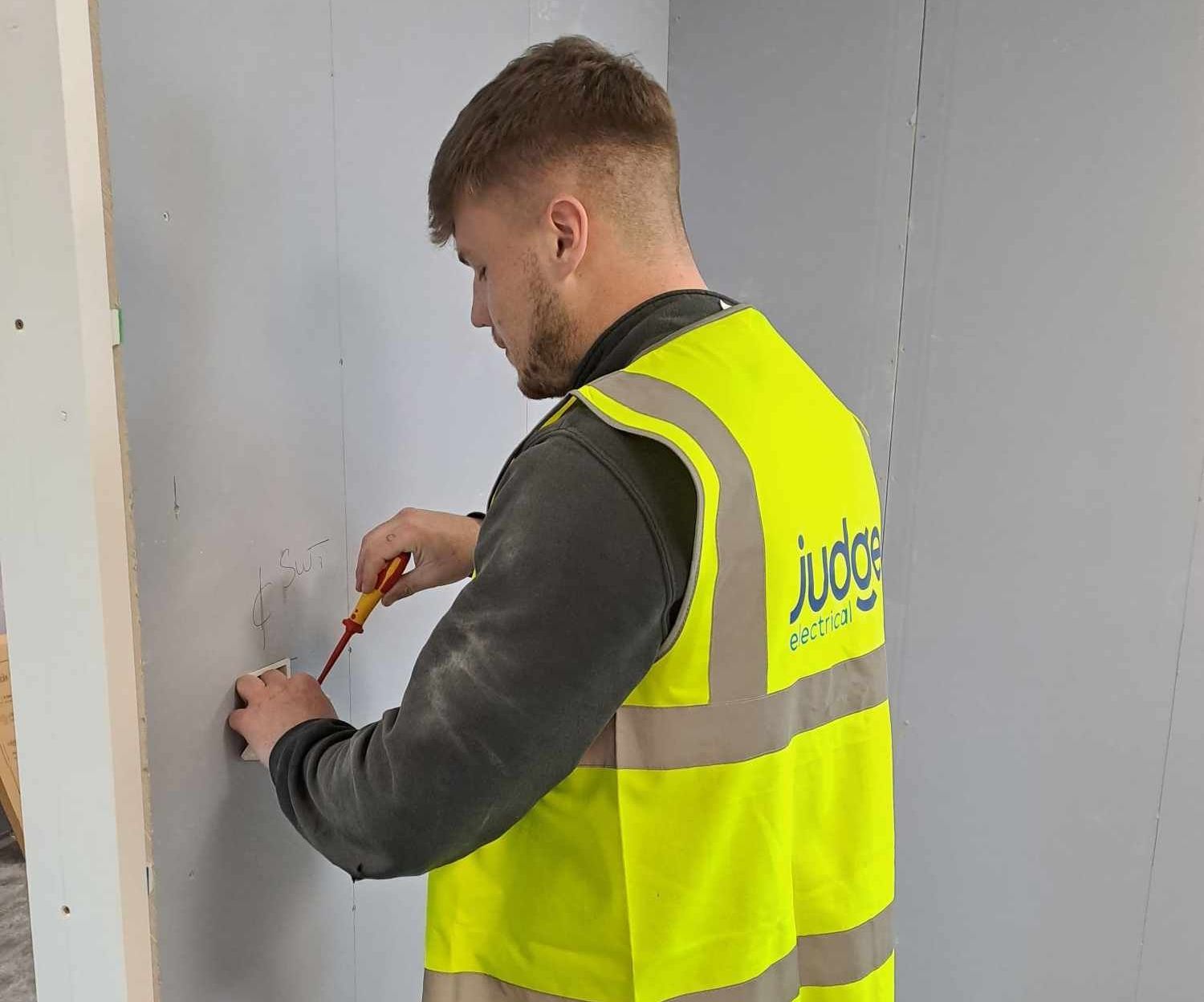 general electrical works, electrician installing a socket