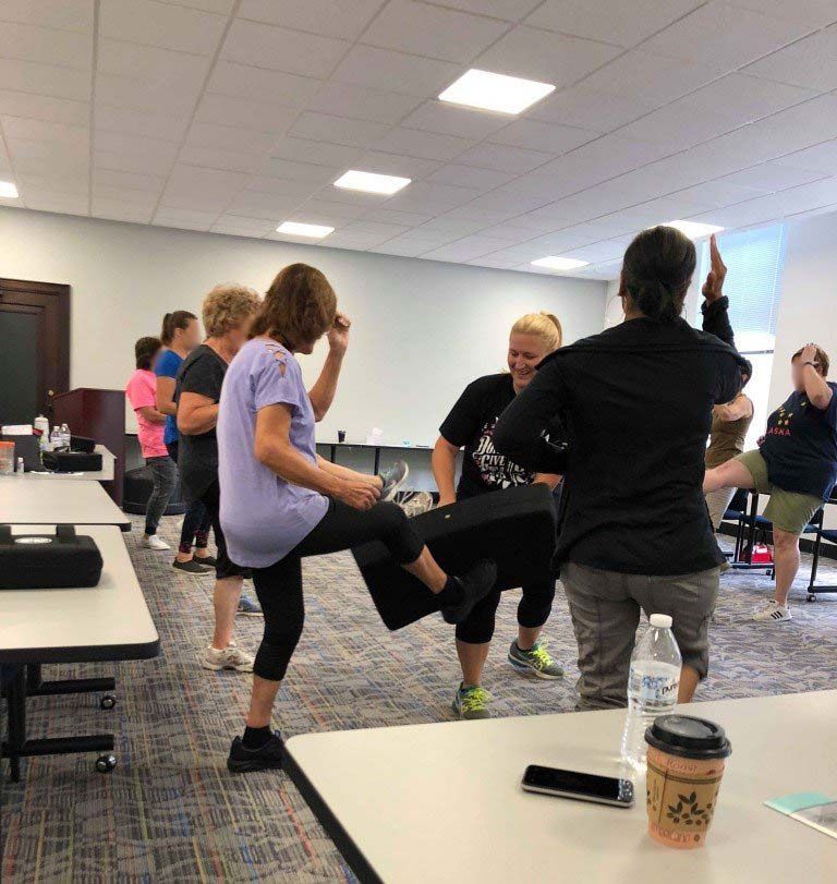 Group of females practicing self-defense techniques at second nature self defense