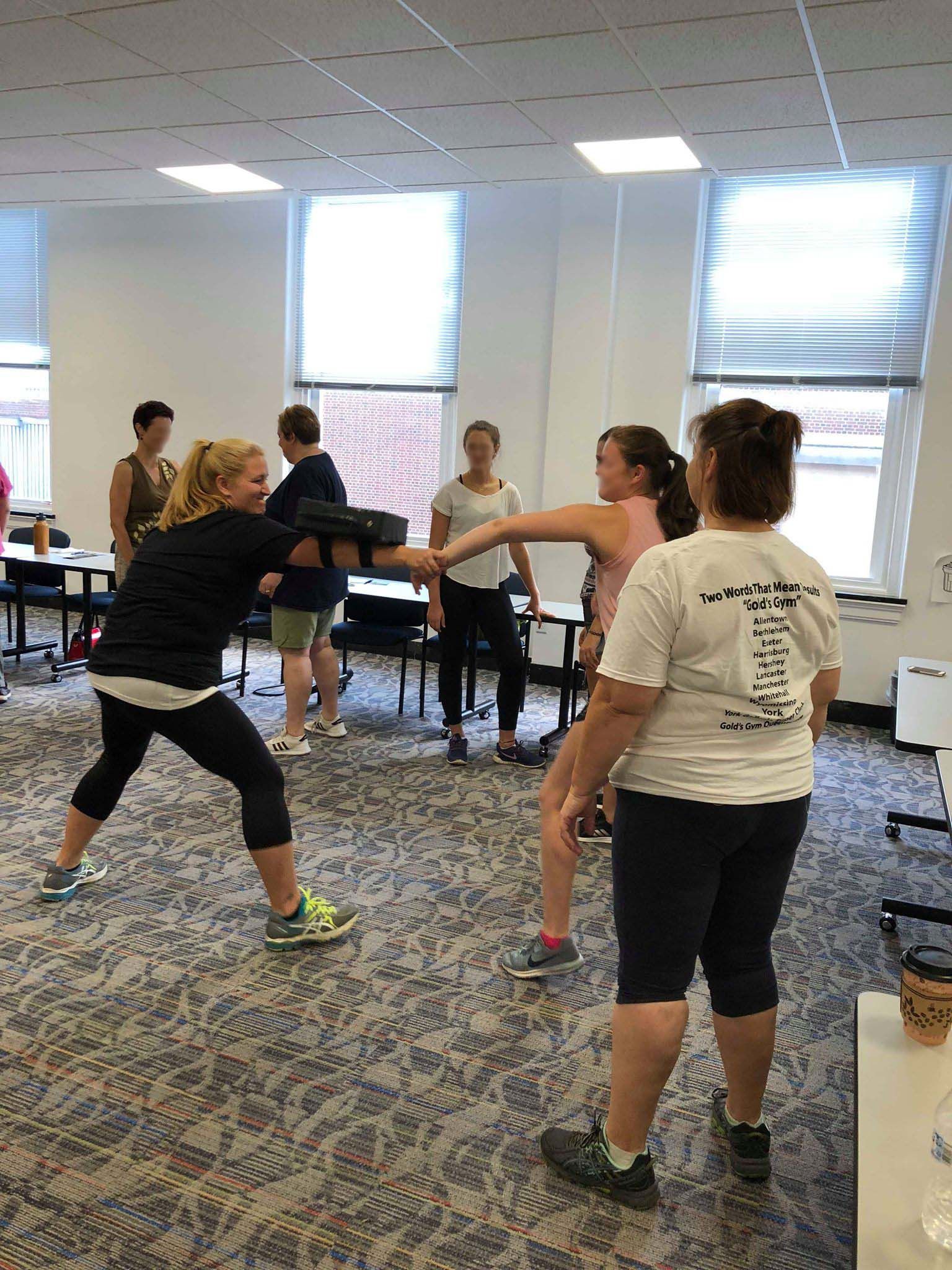 Second Nature Self Defense techniques. Women's self-defense class. Practicing holds.
