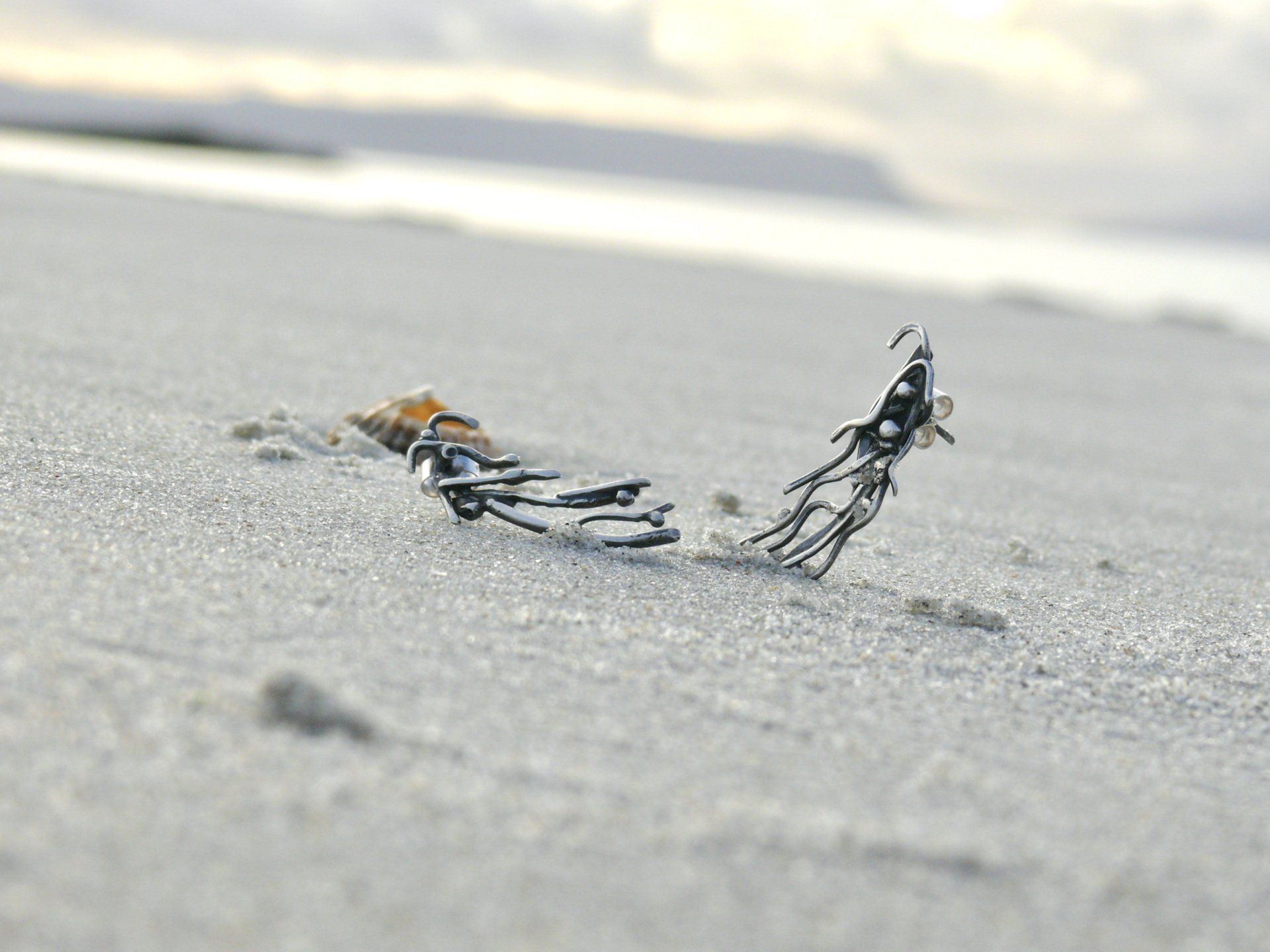 earrings handmade in scotland. Featured on a scottish beach near arisaig
