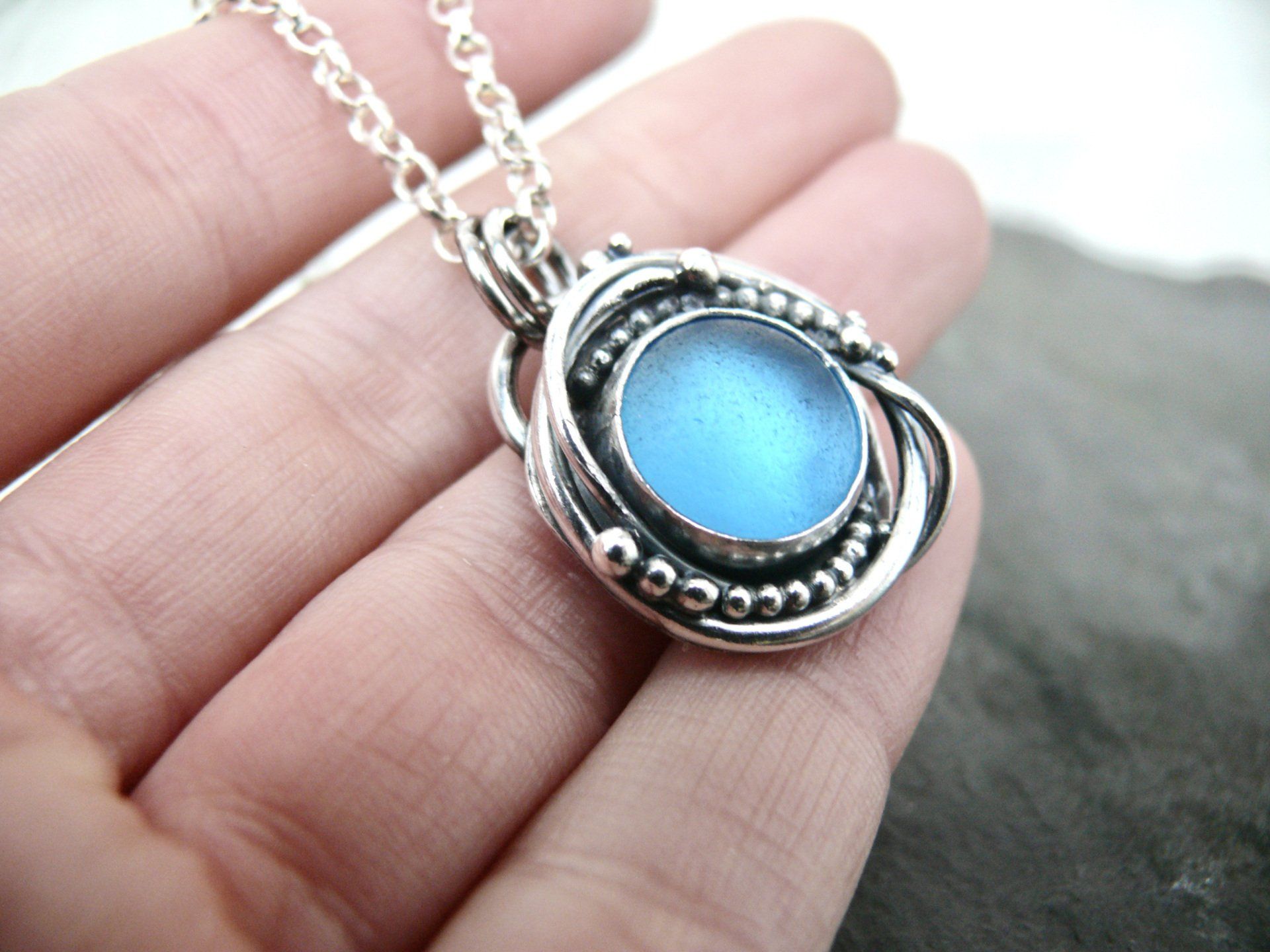 scottish sea glass necklace made in scotland. Blue sea glass with kelpie design