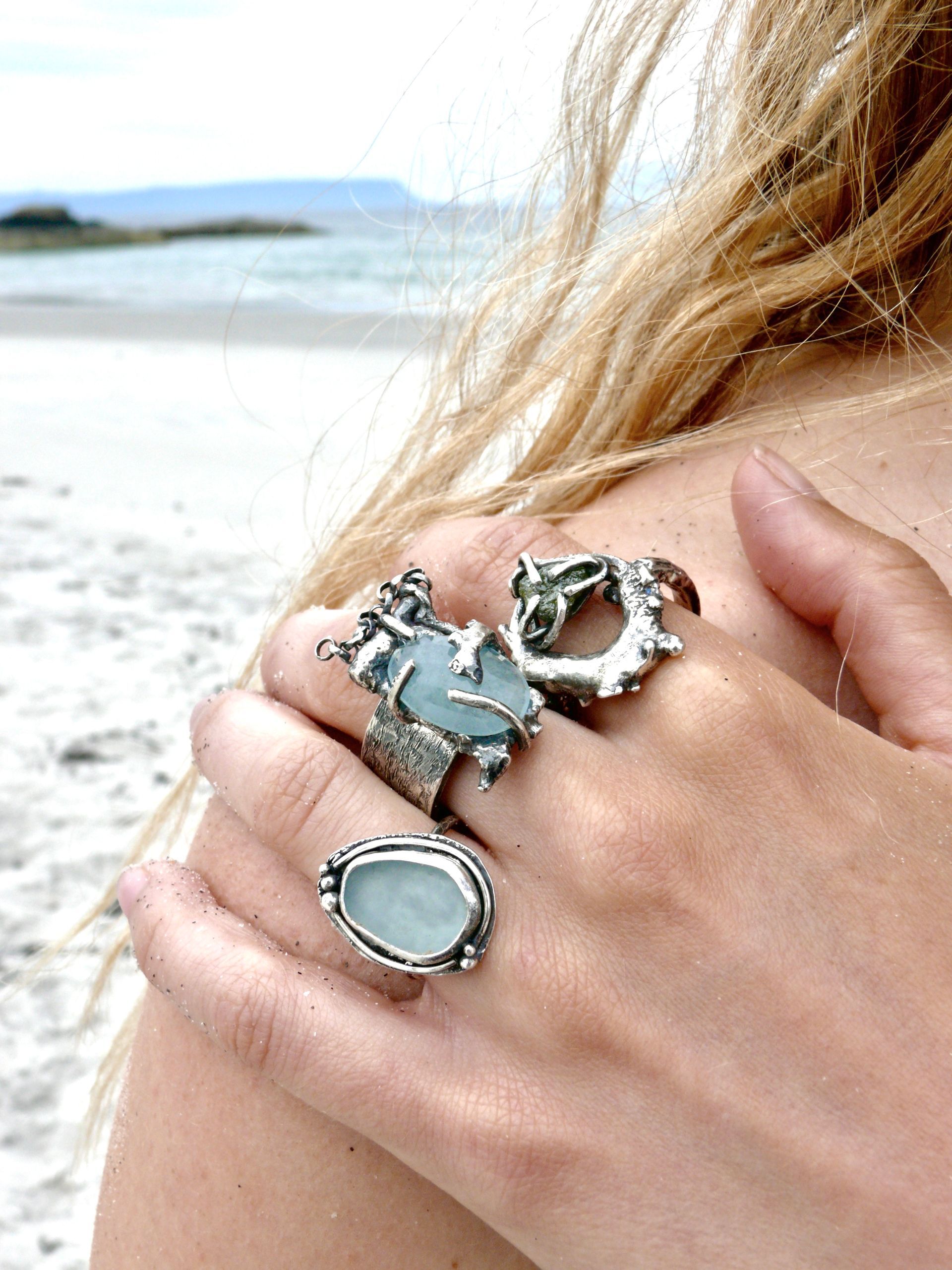 Sea glass and ethically sourced gemstone rings and jewellery. Female model on scottish beach wearing handmade sea glass jewellery from scotland