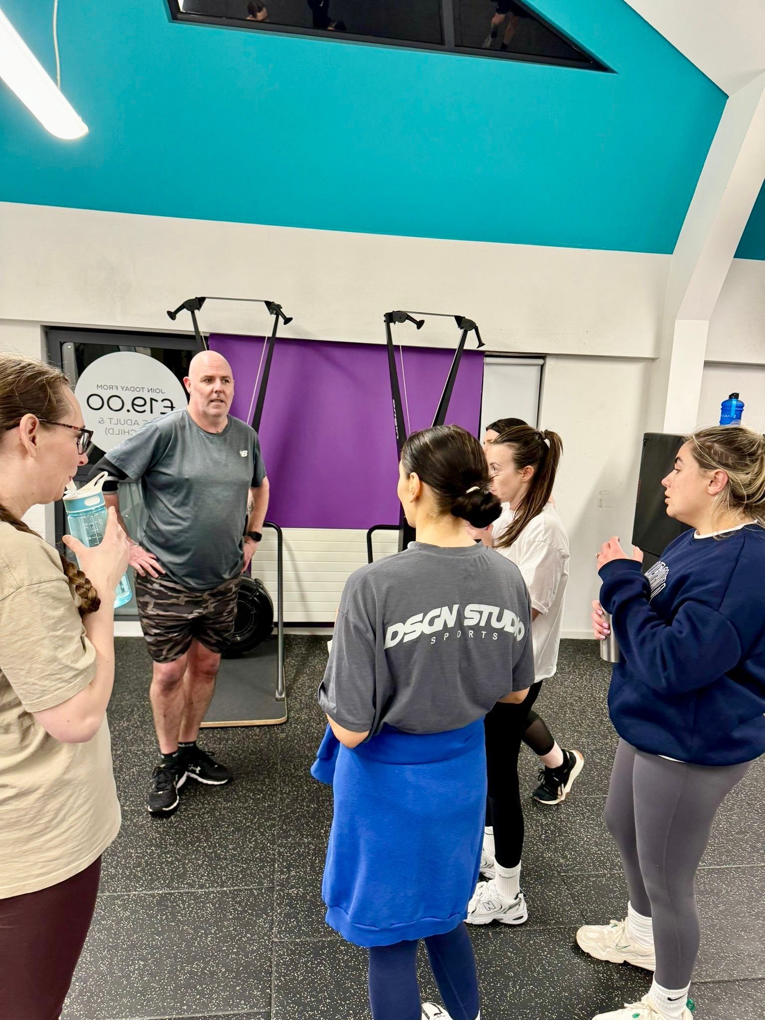 Glasgow PT Academy trainees standing in a group talking during  in level 3 personal training diploma course at Smart Gym in Pollok