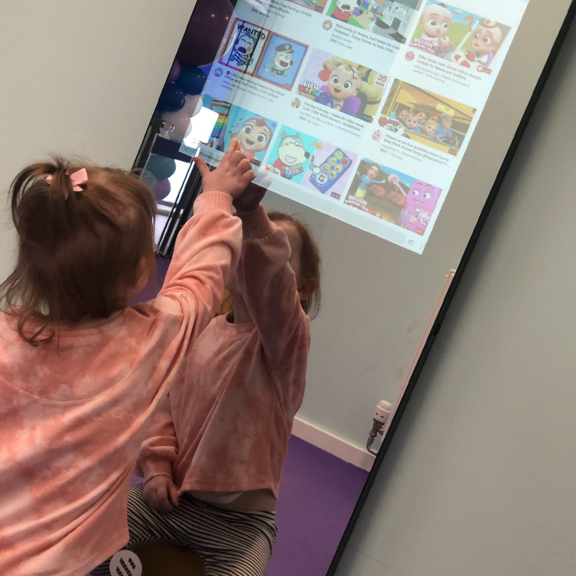 Toddler choosing which YouTube video to watch on Smart Gym's Smart mirror