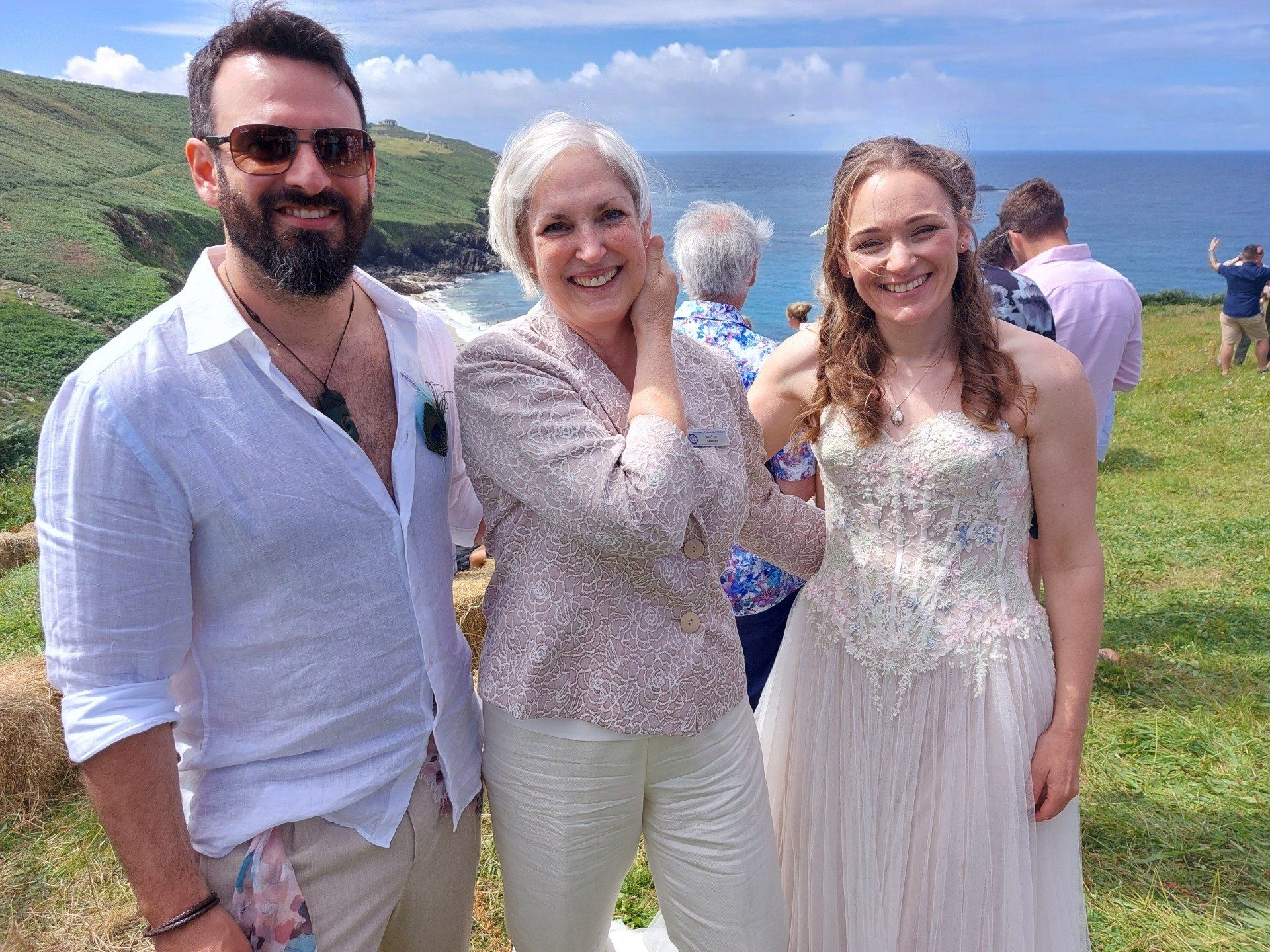 Bride and groom with Sara Price Celebrant after their clifftop wedding ceremony.