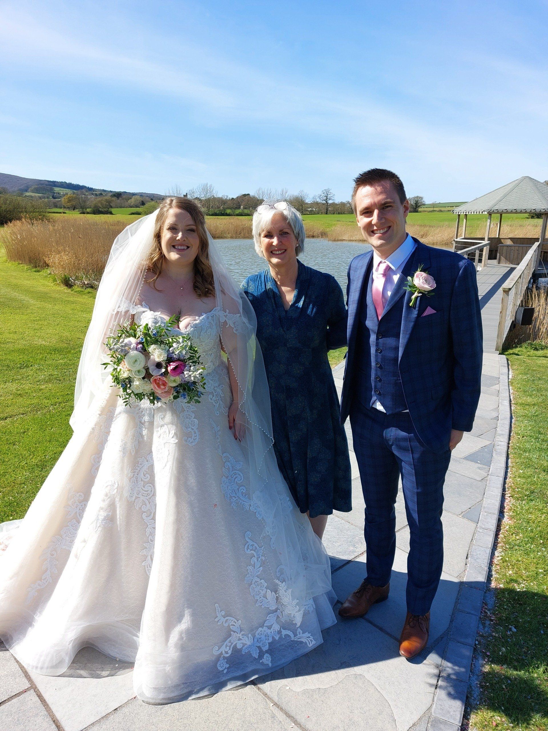 Bride and groom with Sara Price Celebrant in the gardens after their wedding ceremony