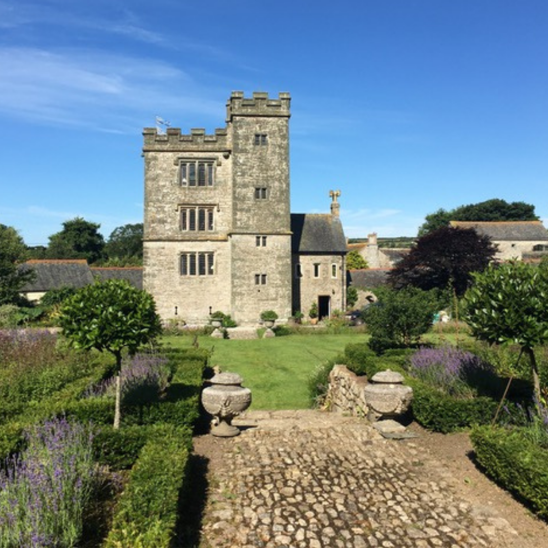 Pengersick Castle in Praa Sands Cornwall basking in the summer sunshine under blue skies