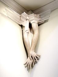'Construction'. 46 a pair of arms high om a wall, with glass wings merging into the crown molding.