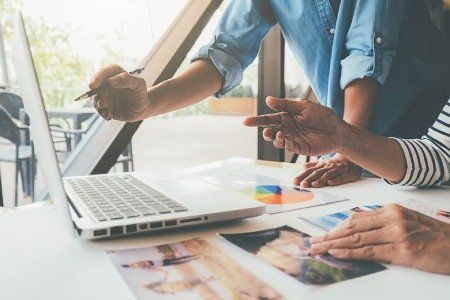 people working at computers with charts